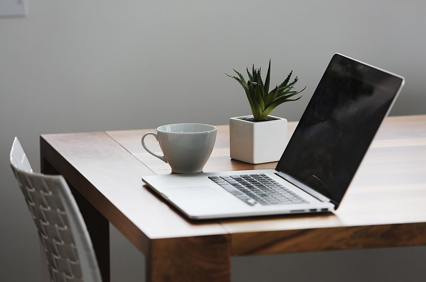 Minimalist Workspace with Laptop, Coffee, and Plant