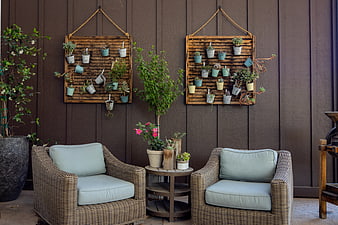 Cozy Outdoor Patio with Wicker Chairs and Vertical Garden