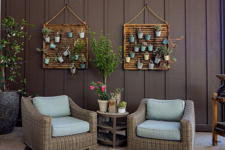 Cozy Outdoor Patio with Wicker Chairs and Vertical Garden