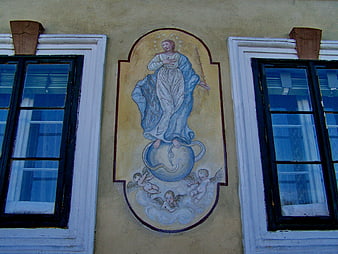 Religious mural of Virgin Mary between windows