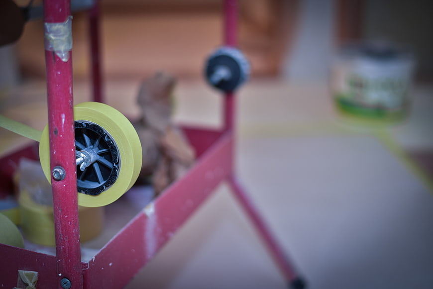 Close-up of yellow tape roll on red metal stand
