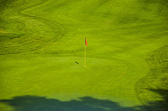 Aerial View of Golf Course Green with Red Flag