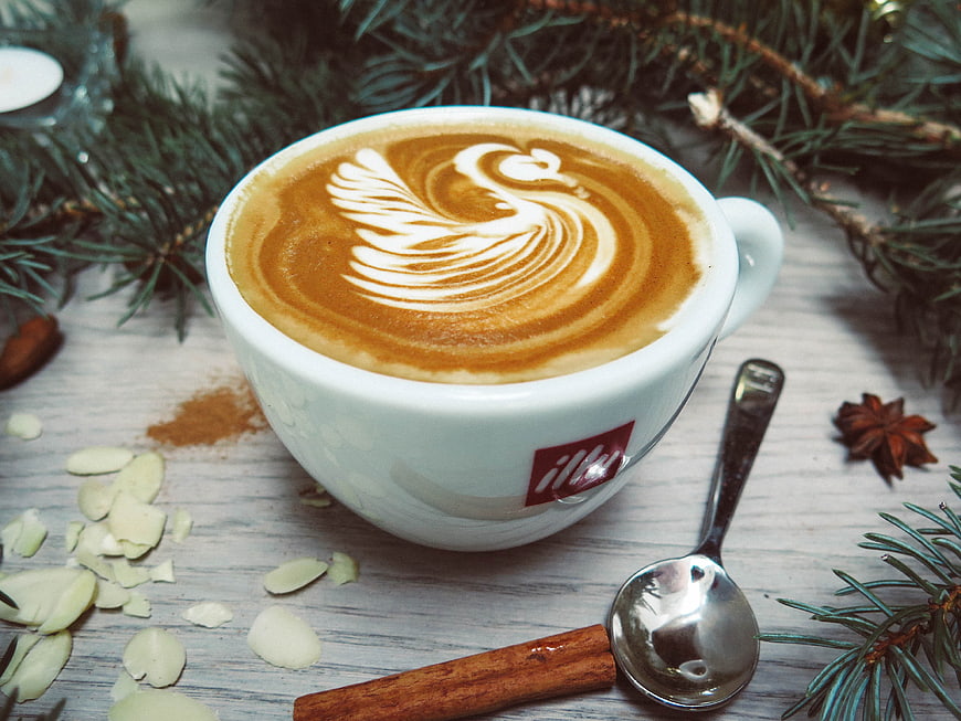 Festive Latte Art Coffee with Pine Branches and Spices
