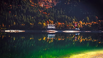 Autumn Lake Reflection with Mountain Lodge and Colorful Forest