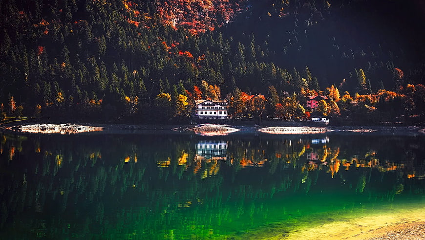 Autumn Lake Reflection with Mountain Lodge and Colorful Forest
