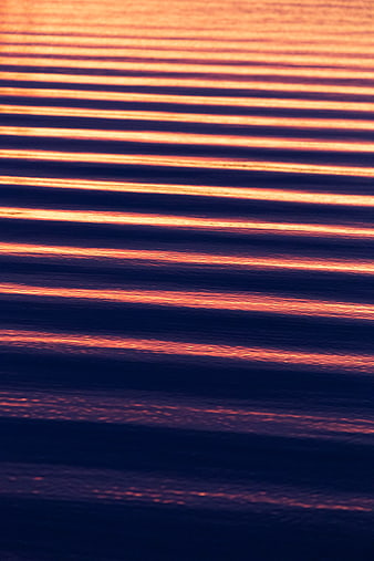 Abstract Sunset Reflections on Rippled Water Surface