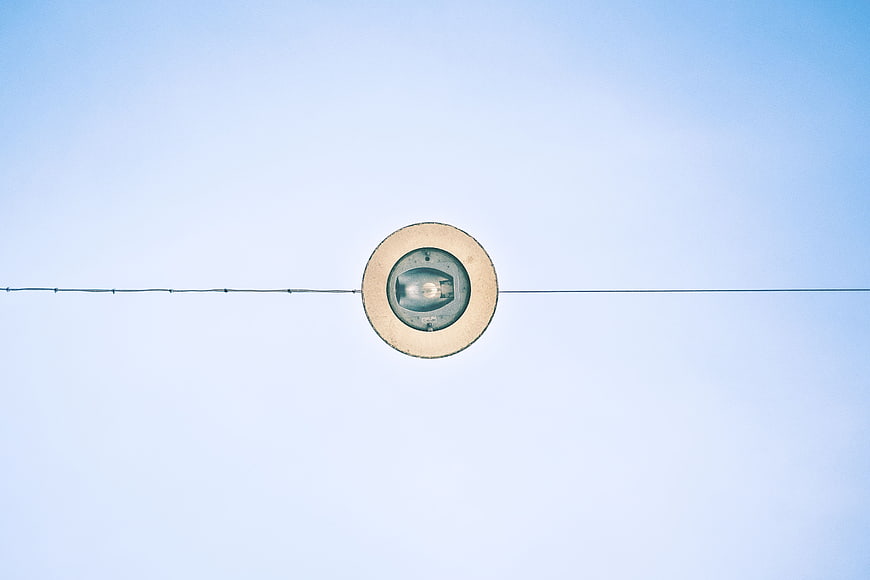 Minimalist Round Street Lamp Against Blue Sky