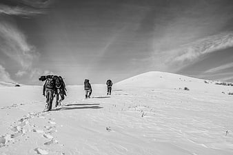Hikers trekking through snowy winter landscape