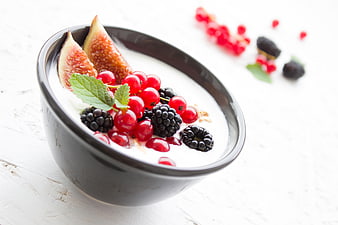 Healthy yogurt bowl with fresh berries and figs