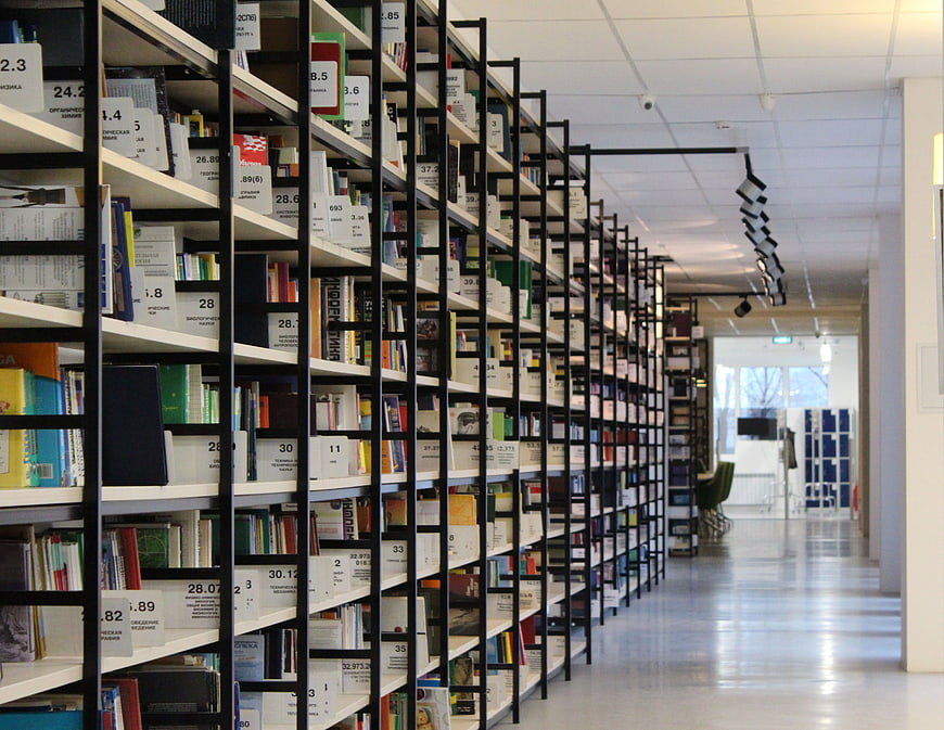 Modern Library Interior with Bookshelves and Aisle