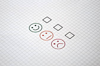 Customer satisfaction survey form with smiley faces and checkboxes on grid paper