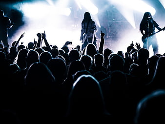 Silhouette of Rock Band Performing on Stage with Crowd