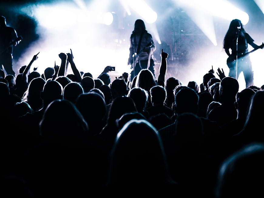Silhouette of Rock Band Performing on Stage with Crowd