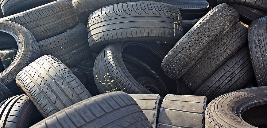 Stack of used car tires in a pile