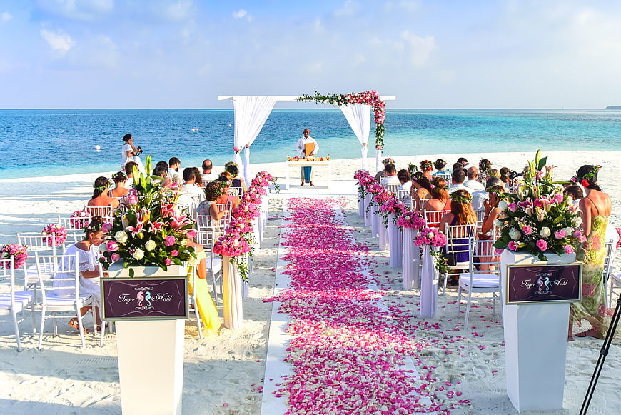 Tropical Beach Wedding Ceremony Setup With Floral Aisle And Ocean View