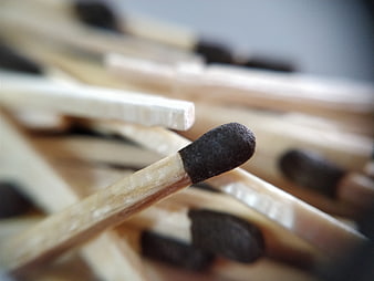 Macro shot of wooden matchsticks with black heads