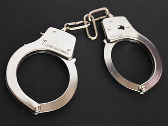 Silver Metal Handcuffs on Black Background