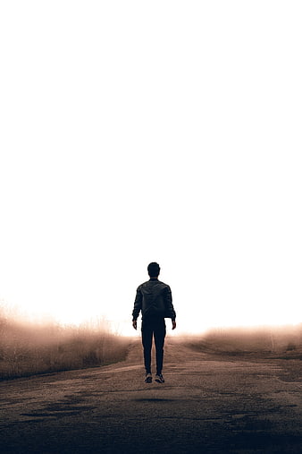 Man Jumping on Foggy Road at Sunrise