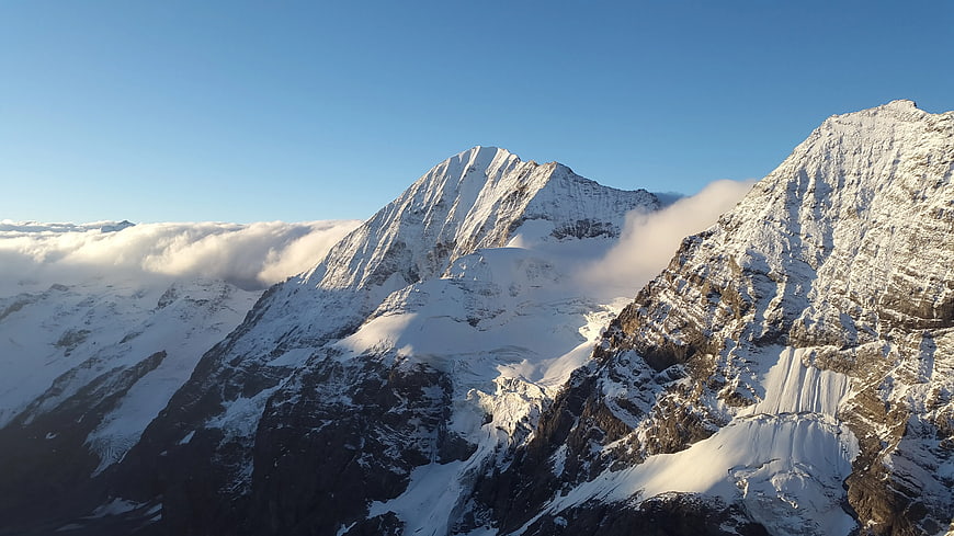 Majestic Snow-Capped Mountain Peaks Above Clouds