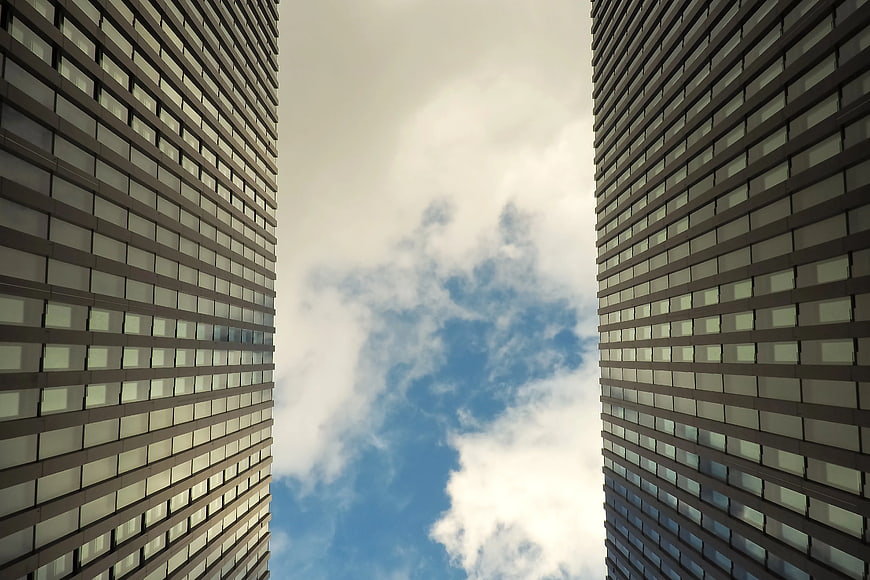Worm's-eye View of Two Skyscrapers Against Cloudy Sky