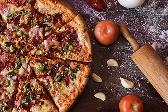Freshly Baked Pizza with Toppings and Rolling Pin on Wooden Table