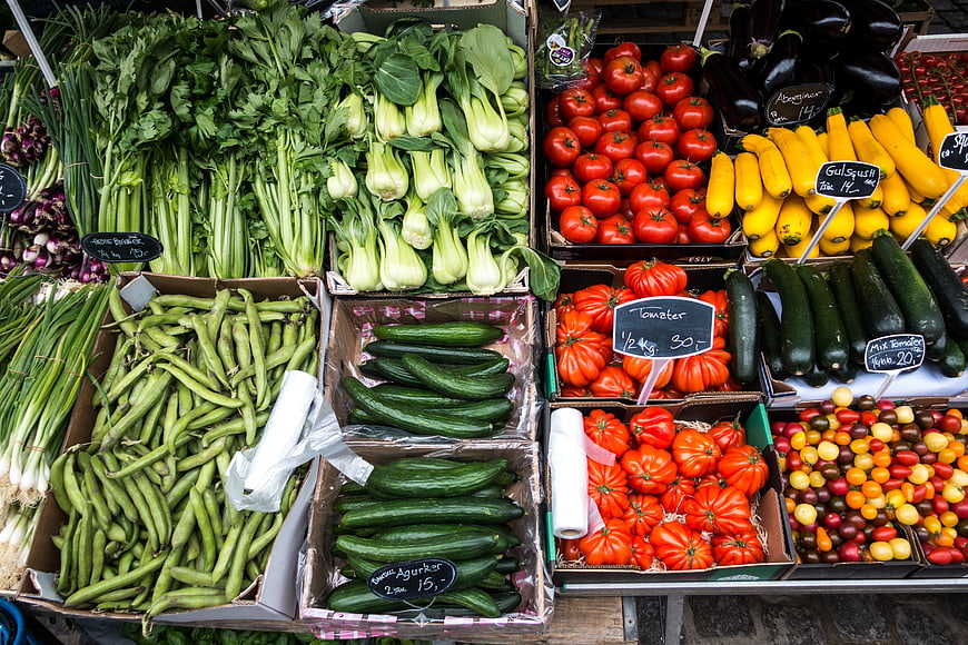 Fresh colorful vegetables displayed in boxes at a market