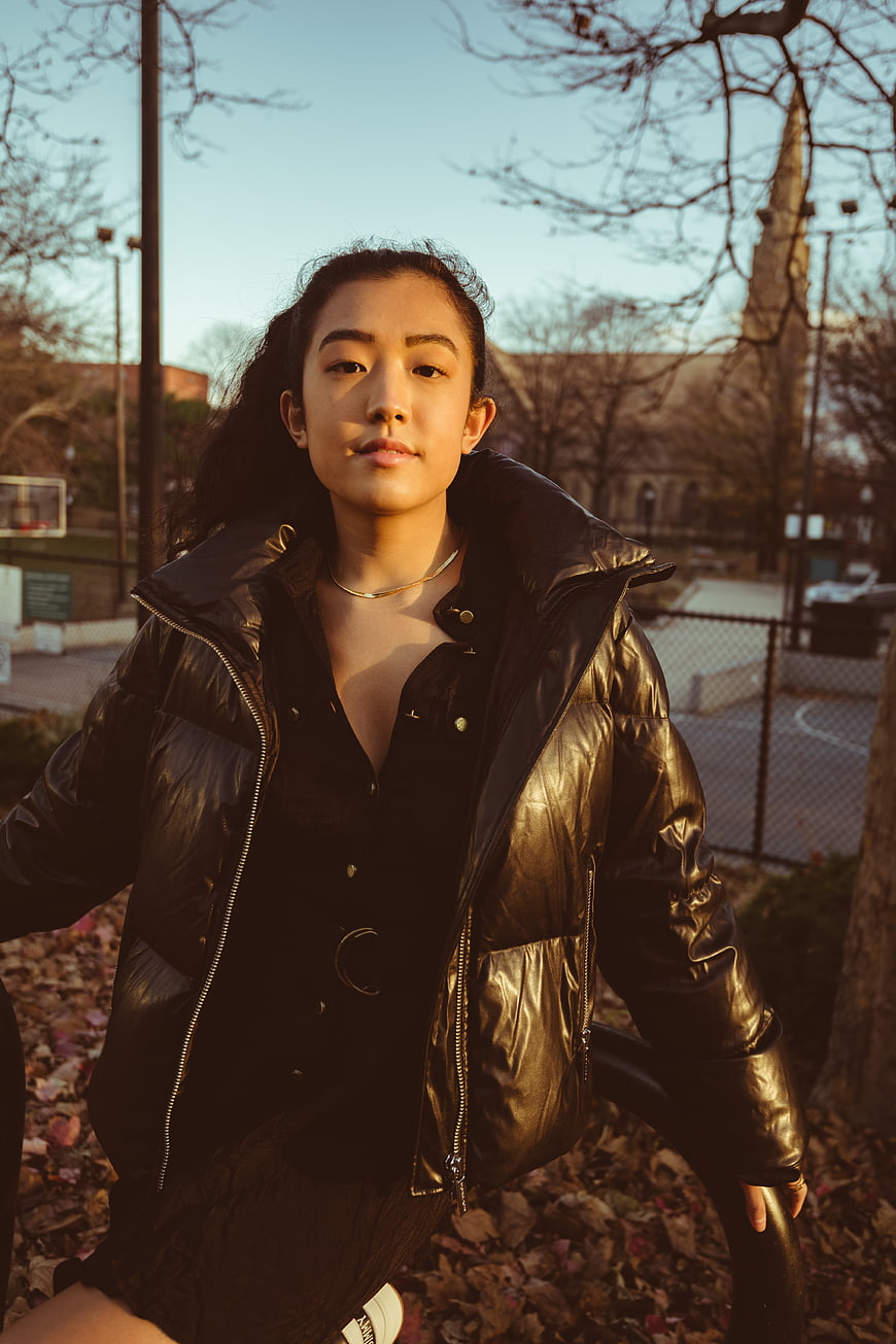 Young Asian Woman in Black Puffer Jacket Outdoors