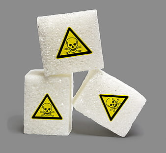 Sugar cubes with poison warning symbol on gray background