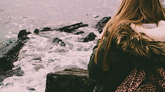 Woman in Parka Looking at Ocean Waves