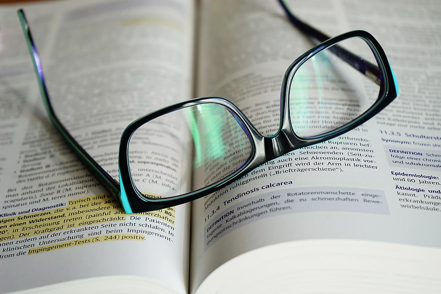 Black Eyeglasses on Open Medical Textbook