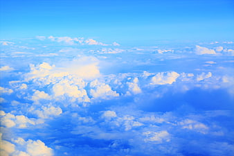 Aerial View of Fluffy White Clouds Against Blue Sky