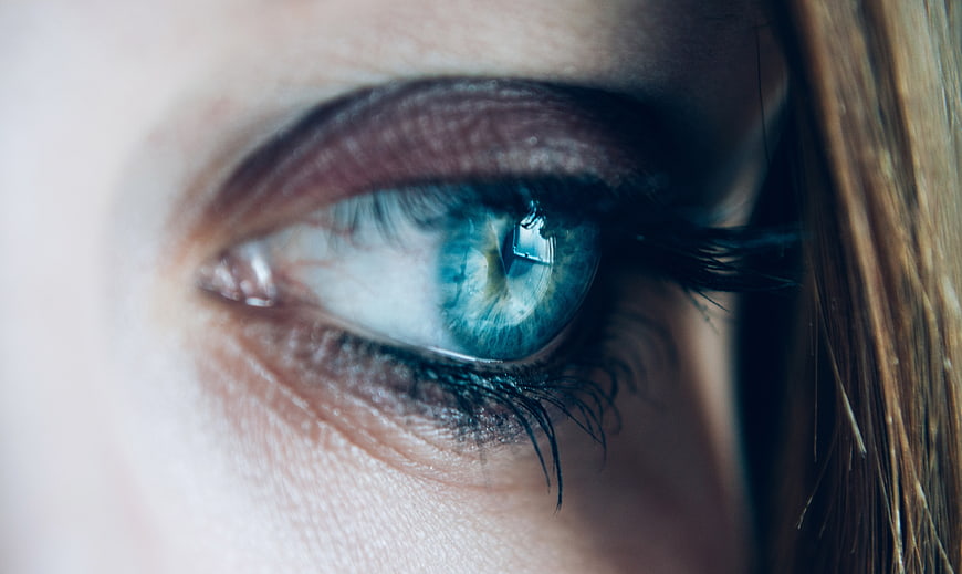Close-up of a striking blue eye with detailed iris texture