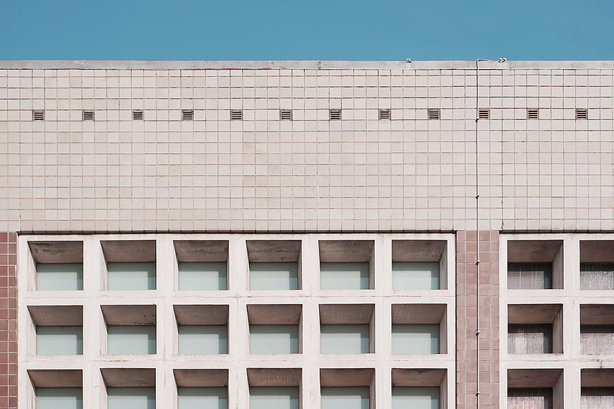 Modernist Building Facade with Grid Windows and Blue Sky