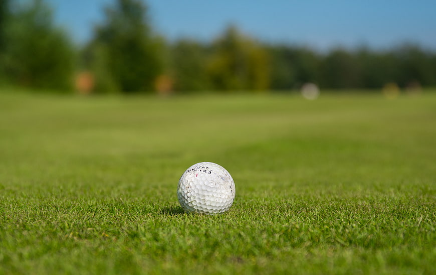 Close-up of a golf ball on a green grass course
