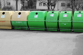Row of Green and Yellow Recycling Bins for Glass Waste