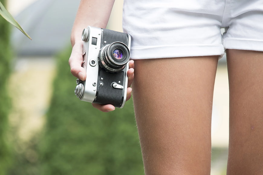 Woman Holding Vintage Retro Camera Outdoors