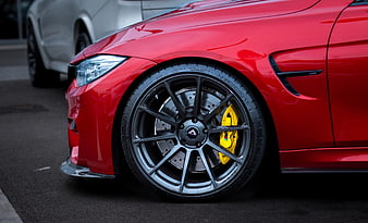 Close-up of Red BMW M4 Front Wheel and Yellow Brake Caliper