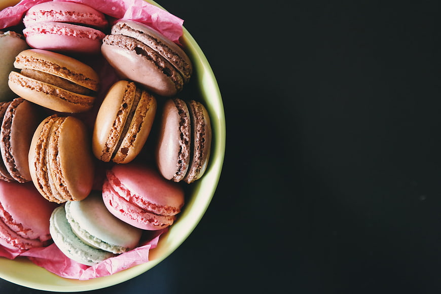 Colorful macarons in a bowl with copy space