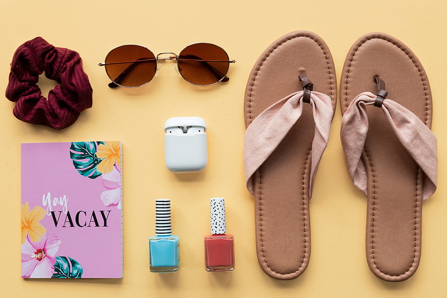 Summer Vacation Flat Lay with Sandals, Sunglasses, and Travel Essentials