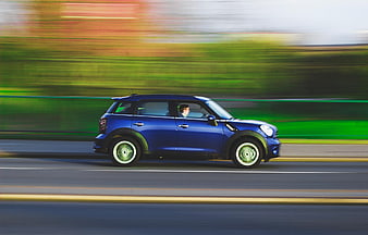 Blue Mini Cooper Driving Fast on Road with Motion Blur