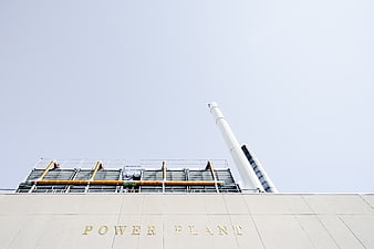 Modern Power Plant Building with Smokestack and Cooling Towers