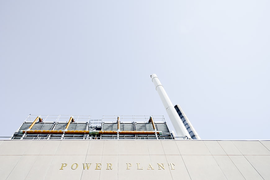Modern Power Plant Building with Smokestack and Cooling Towers