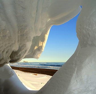 View of Pacific Ocean Beach Through Snow Cornice