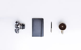 Minimalist Flat Lay of Camera, Notebook, Pen, and Coffee Cup