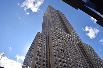 Low angle view of Empire State Building against blue sky