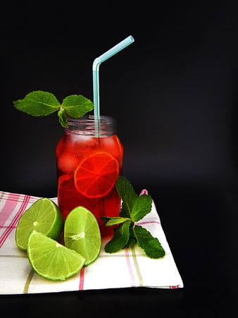 Red Iced Beverage in Mason Jar with Lime and Mint Garnish