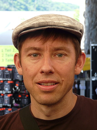 Close-up portrait of a man wearing a plaid flat cap
