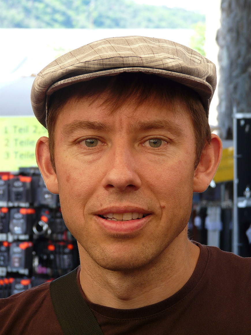 Close-up portrait of a man wearing a plaid flat cap
