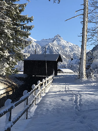 Snowy Mountain Path with Wooden Cabin and Fence