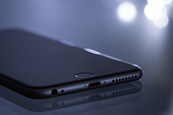 Closeup of Black Smartphone Bottom Edge with Bokeh